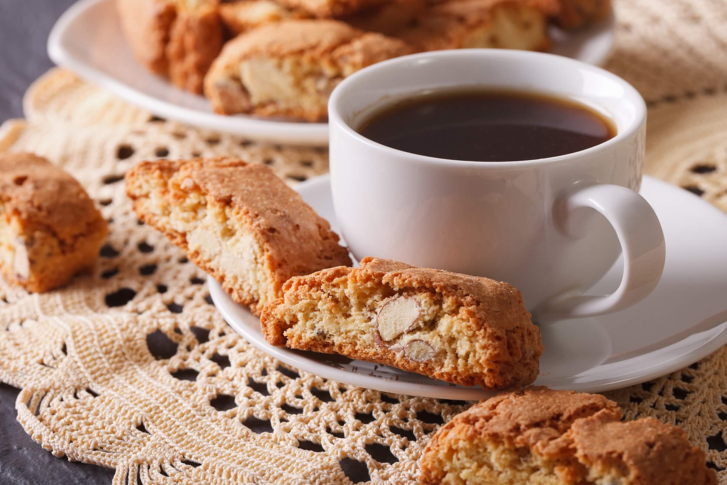 A cup of coffee and a plate of biscotti